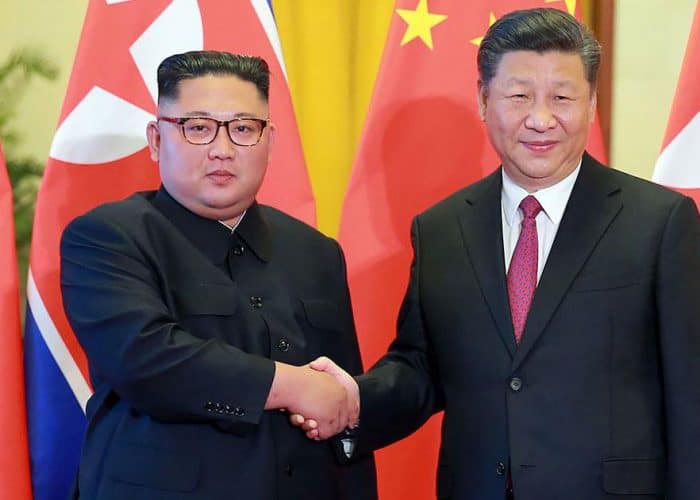 A newspaper featuring a front page photo of Chinese President Xi Jinping shaking hands with North Korean leader Kim Jong Un (not seen) during Xi’s visit to Pyongyang. (File/AFP)