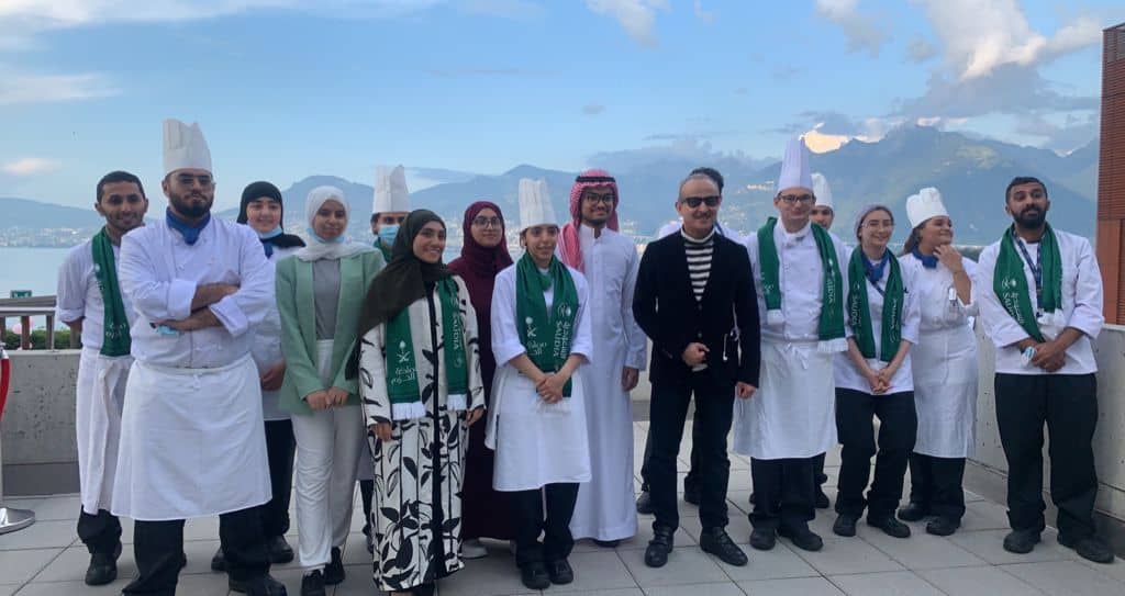 Consul General in Geneva Mohammed Al-Shubrami participates with students in the celebration of the National Day